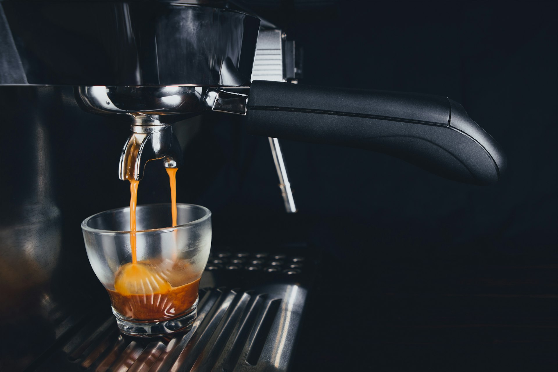 An espresso machine in action, highlighting the precision required in water temperature to achieve the perfect shot.