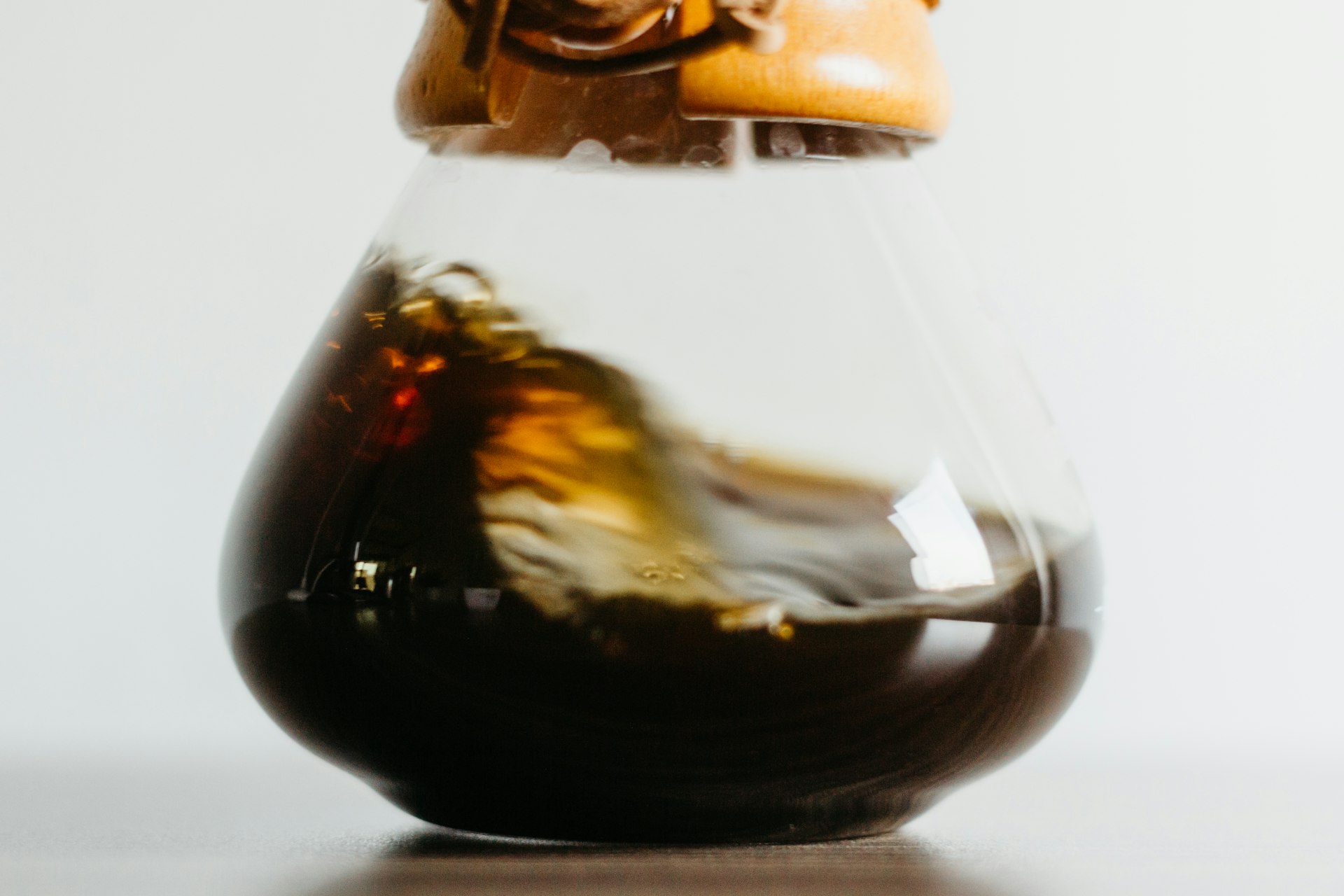  A glass coffee pot filled with steaming decaf coffee, showcasing its rich color and aroma despite reduced caffeine content.