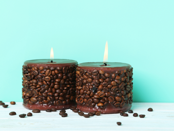 An image of two DIY burning candles made from coffee grounds demonstrates the reuse of coffee grounds.
