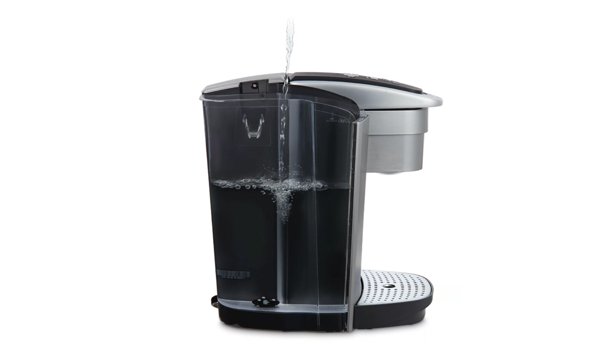 Close-up view of a Keurig coffee maker, highlighting the water reservoir compartment on the side