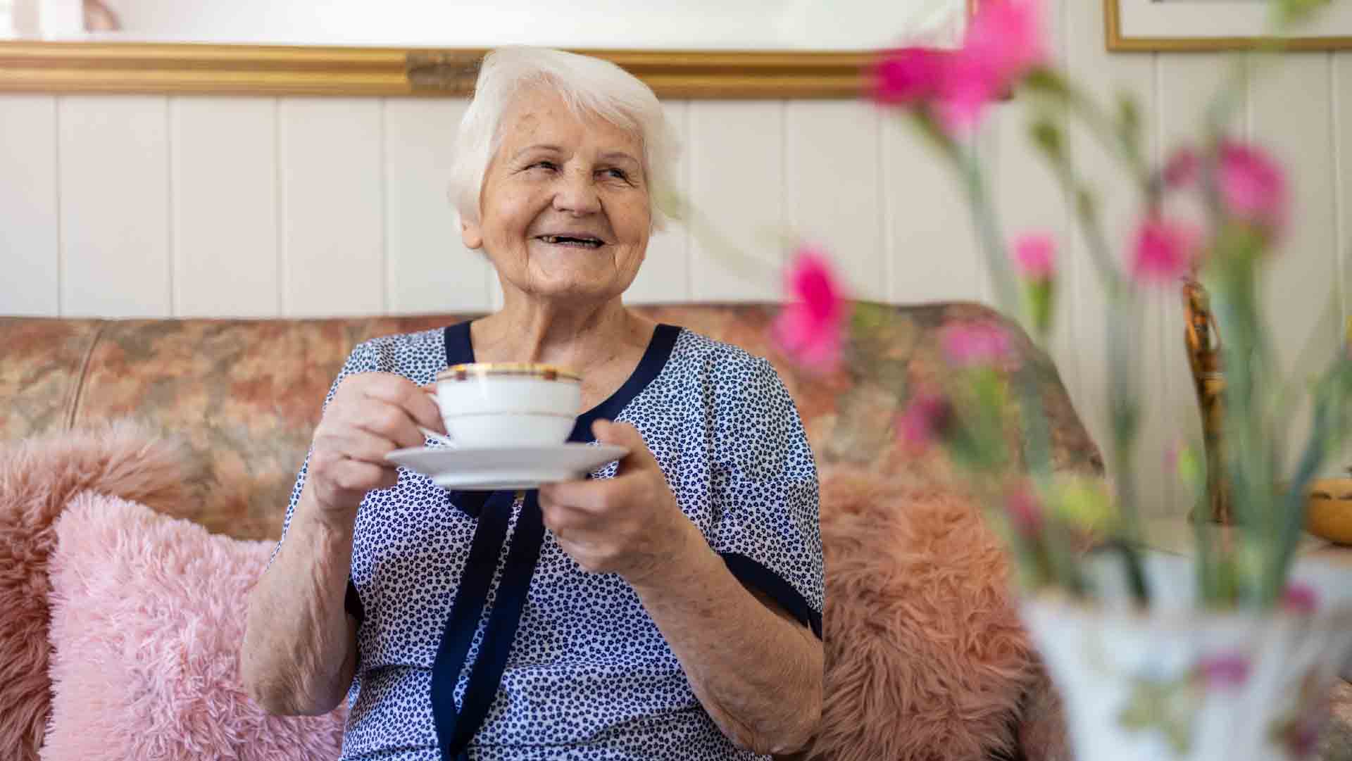 An image of an older adult to rep taking a cup of Coffee. It represents the aging population with dementia and Alzheimer's Disease. Drinking Coffee May prevent Alzheimer's Disease.