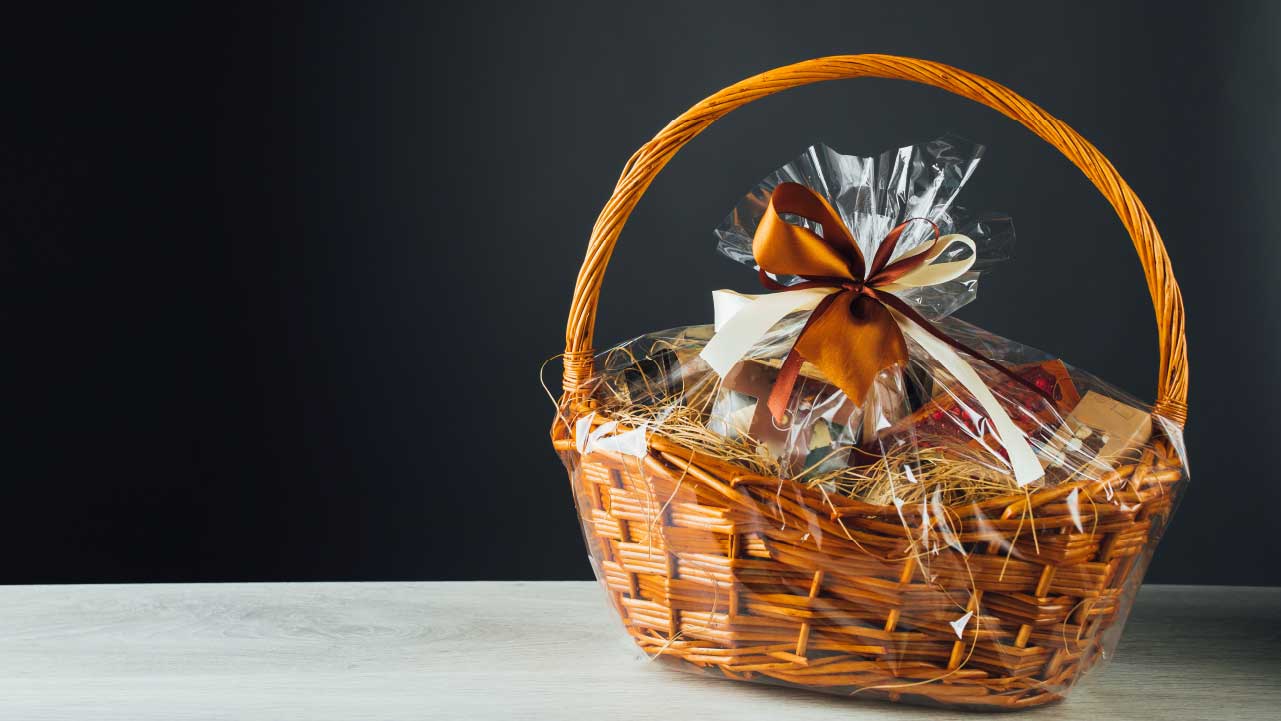 A beautifully arranged gift basket with assorted coffee beans, flavored syrups, and perhaps a grinder highlights the gift's diversity and thoughtfulness.