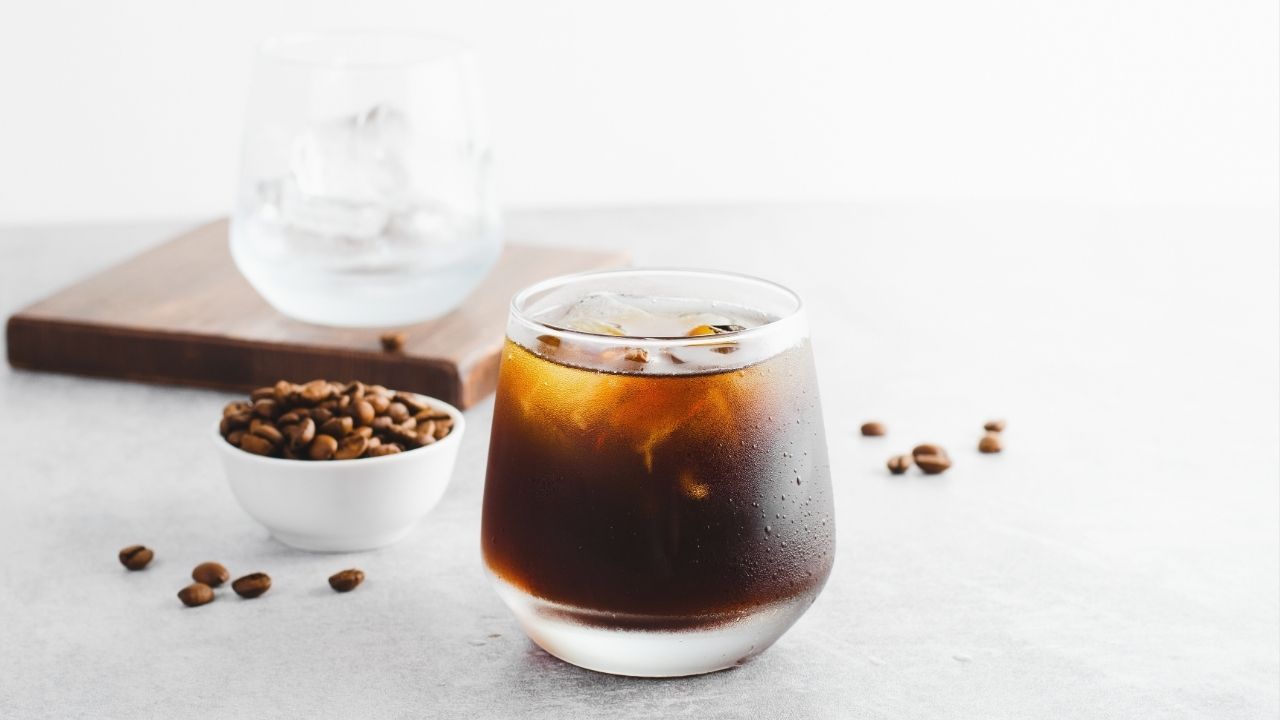 Cold brew coffee and roasted coffee beans, highlighting coffee trends for 2024.