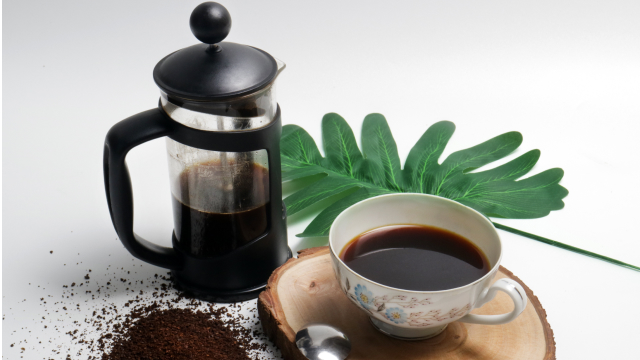 French press half filled with cold brew coffee, showcasing preparation of summer coffee drinks.