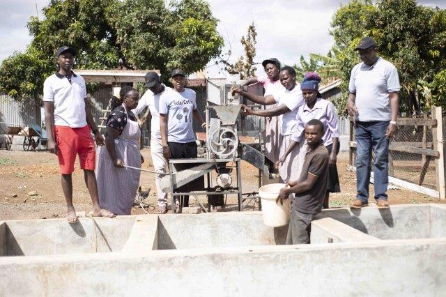 Solai coffee team and farmers pose for an image in a coffee miller.