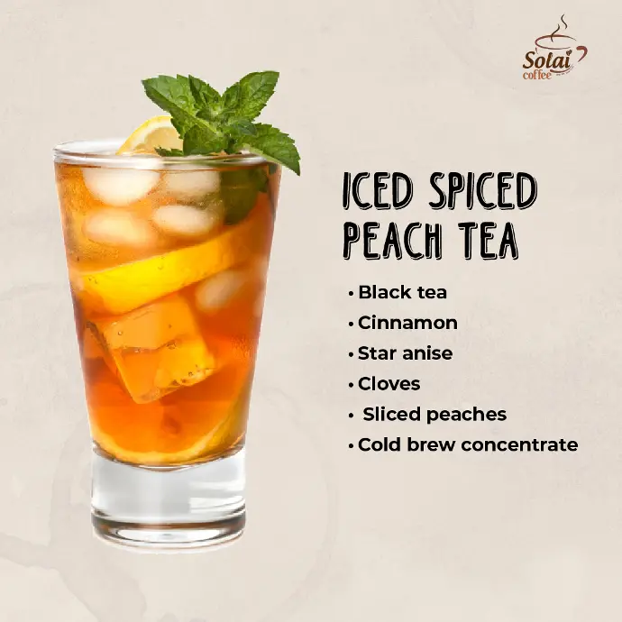 Iced Spiced Peach Tea A vibrant iced spiced peach tea in a tall glass, garnished with peach slices, cinnamon and mint.