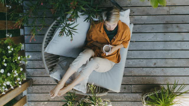 A coffee lover enjoying a mindful morning coffee routine, savoring each sip while relaxing in a cozy seat.