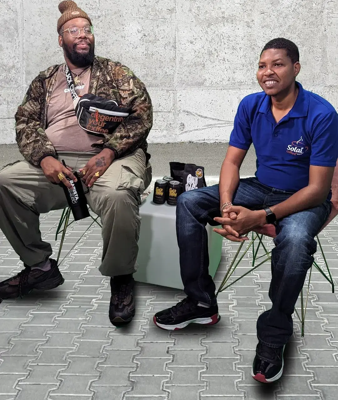 Peter Kuria and Bartholomew sit together in a studio, preparing for their podcast interview at Unapologetic Studios, Memphis, ready to discuss coffee, heritage, and justice.