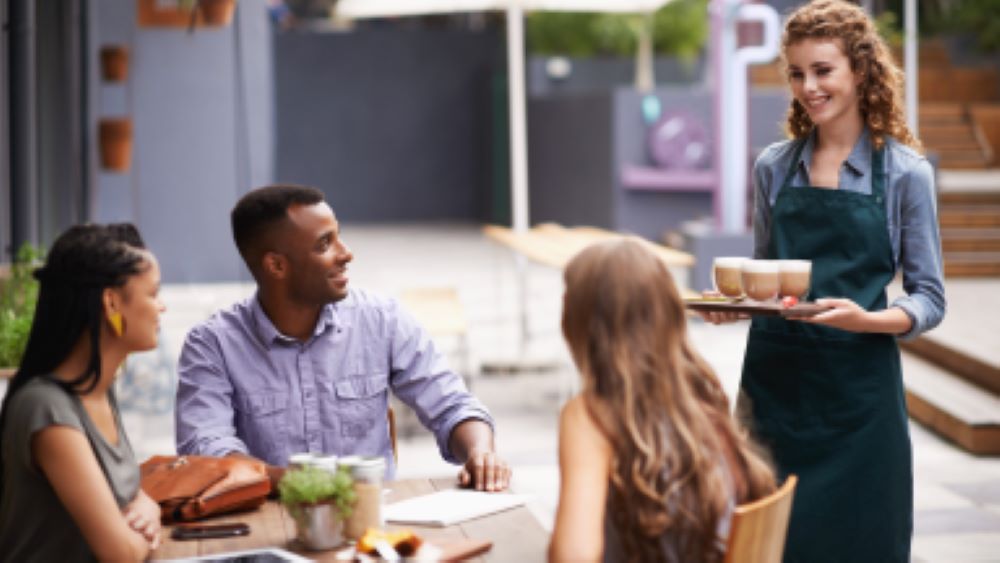 A warm, inviting coffee shop where younger consumers enjoy pumpkin spice lattes. 