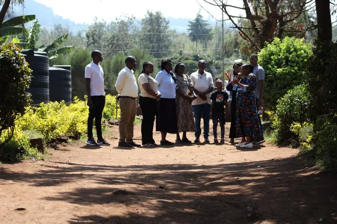The deputy headteacher leads the Solai Coffee team through the school compound, pointing out different areas and providing background information.. Activity 1