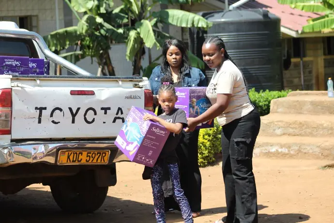Members of the Solai Coffee team handing out gifts to students and teachers, with smiles and expressions of gratitude shared among the crowd. Activity 4