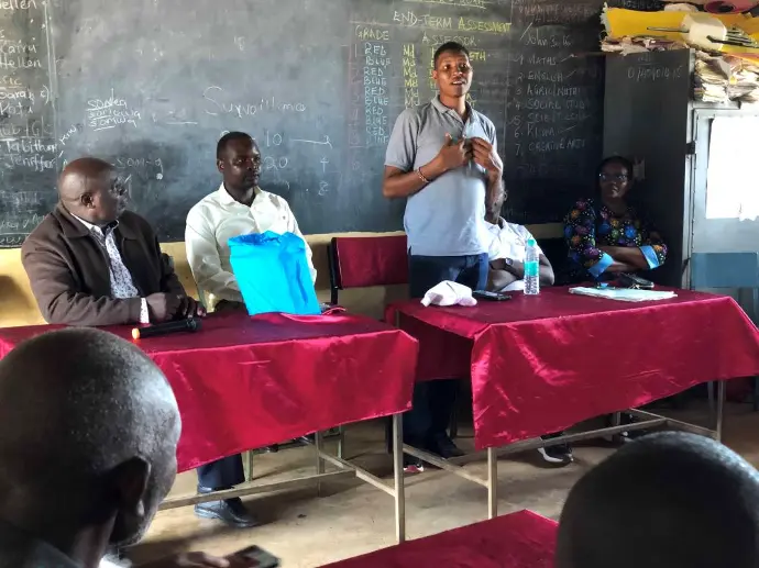 Members of the Solai Coffee team handing out gifts to students and teachers, with smiles and expressions of gratitude shared among the crowd. Activity 3