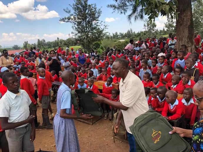 Members of the Solai Coffee team handing out gifts to students and teachers, with smiles and expressions of gratitude shared among the crowd. Activity 2