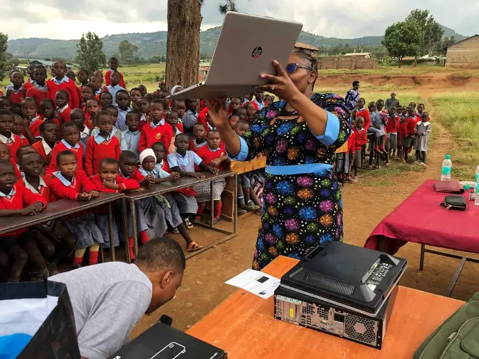 Students joyfully cheering and clapping after receiving gifts from the Solai Coffee team, celebrating the special moment. Activity 2