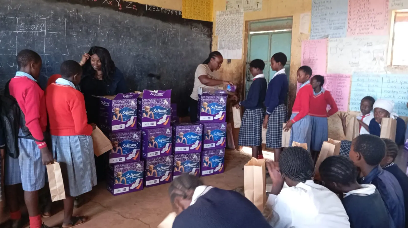Members of the Solai Coffee team handing out gifts to students and teachers, with smiles and expressions of gratitude shared among the crowd. Activity 5