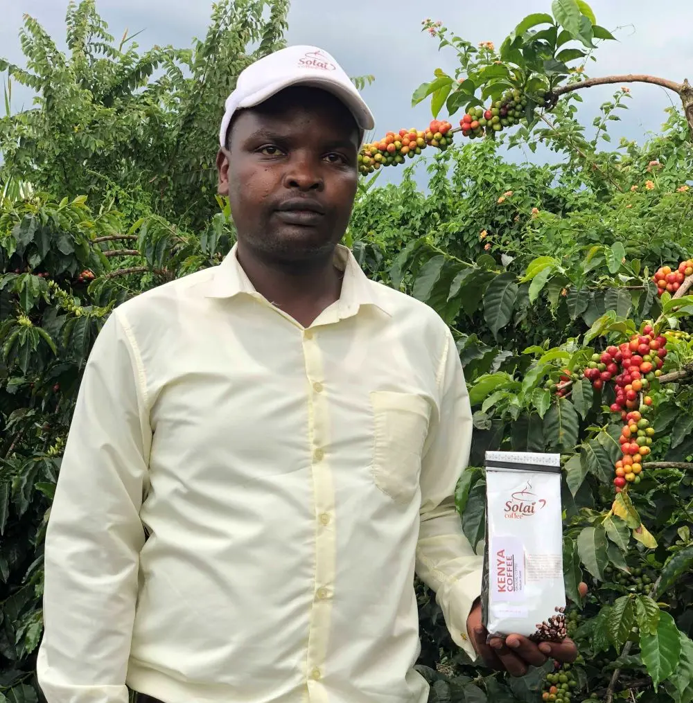 Solai coffee team posing for a photo holding solai coffee pack 