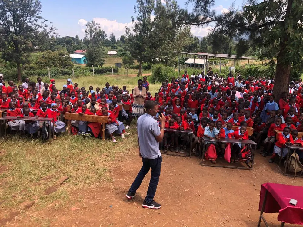 Peter from the Solai Coffee team addressing the students, teachers, and guests, speaking passionately to the attentive crowd. Activity 1