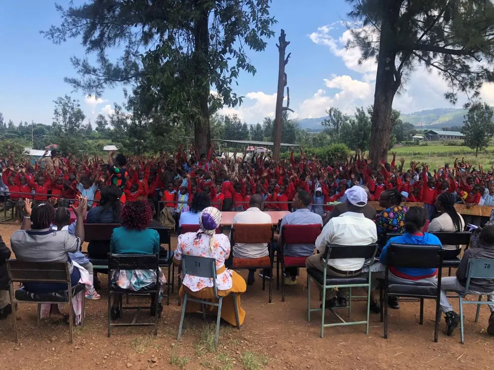 Students, teachers, and Solai Coffee team members gathered outdoors, capturing a moment of community and partnership.