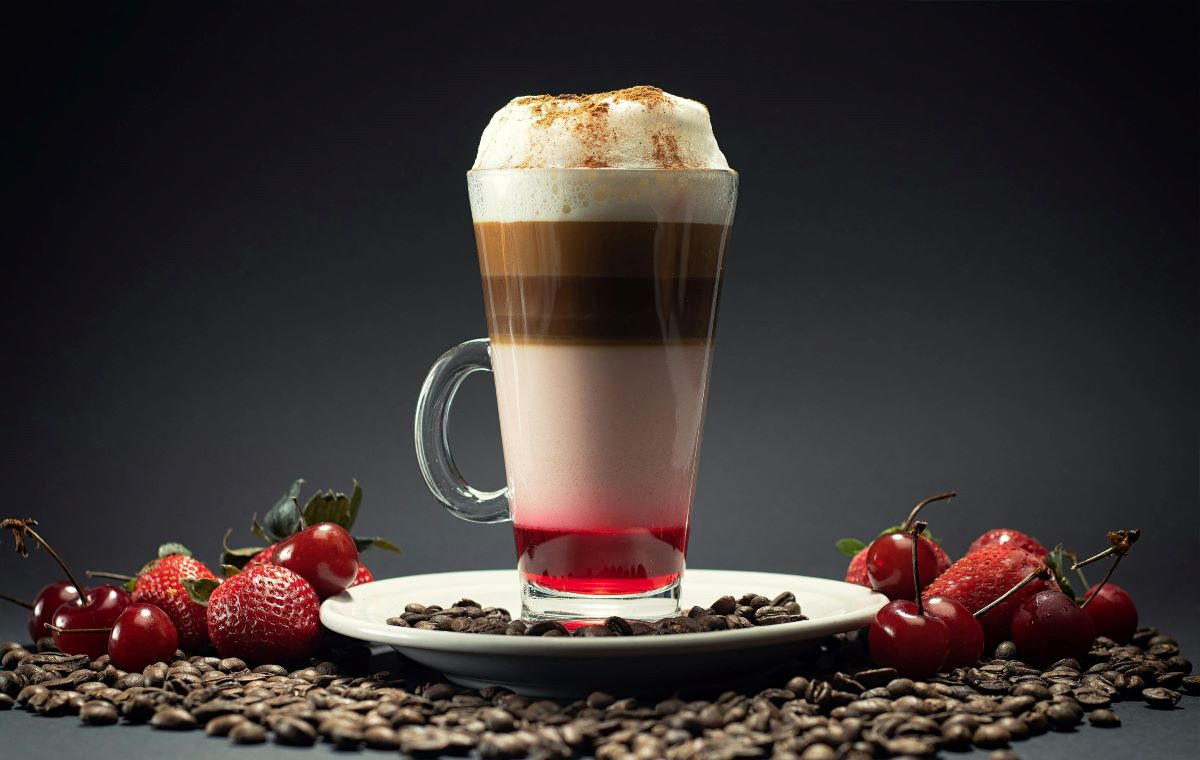 A specialty coffee creation combining coffee and berries, featuring visible layers highlighting customization and personalization.