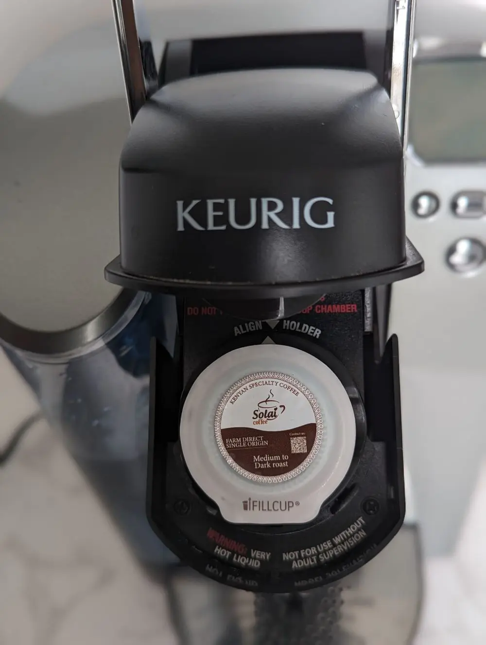 A Keurig machine A Keurig machine with a Solai Coffee single-origin K-Cup loaded, ready to brew.