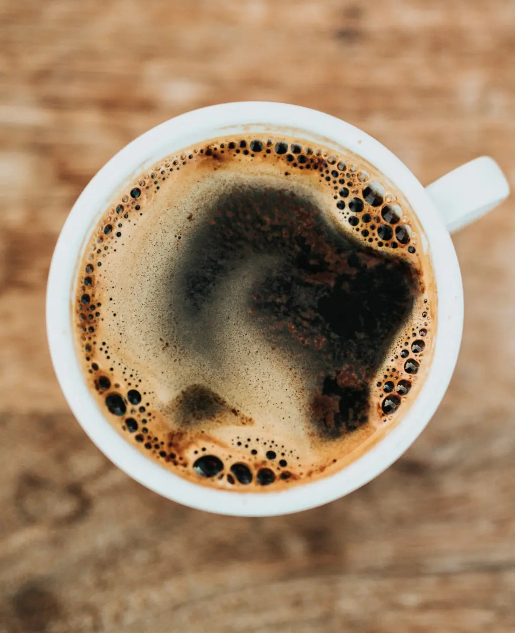 Kahawa Chungu A white ceramic cup filled with kahawa chungu, the traditional Kenyan coffee brewed along the coastal region.