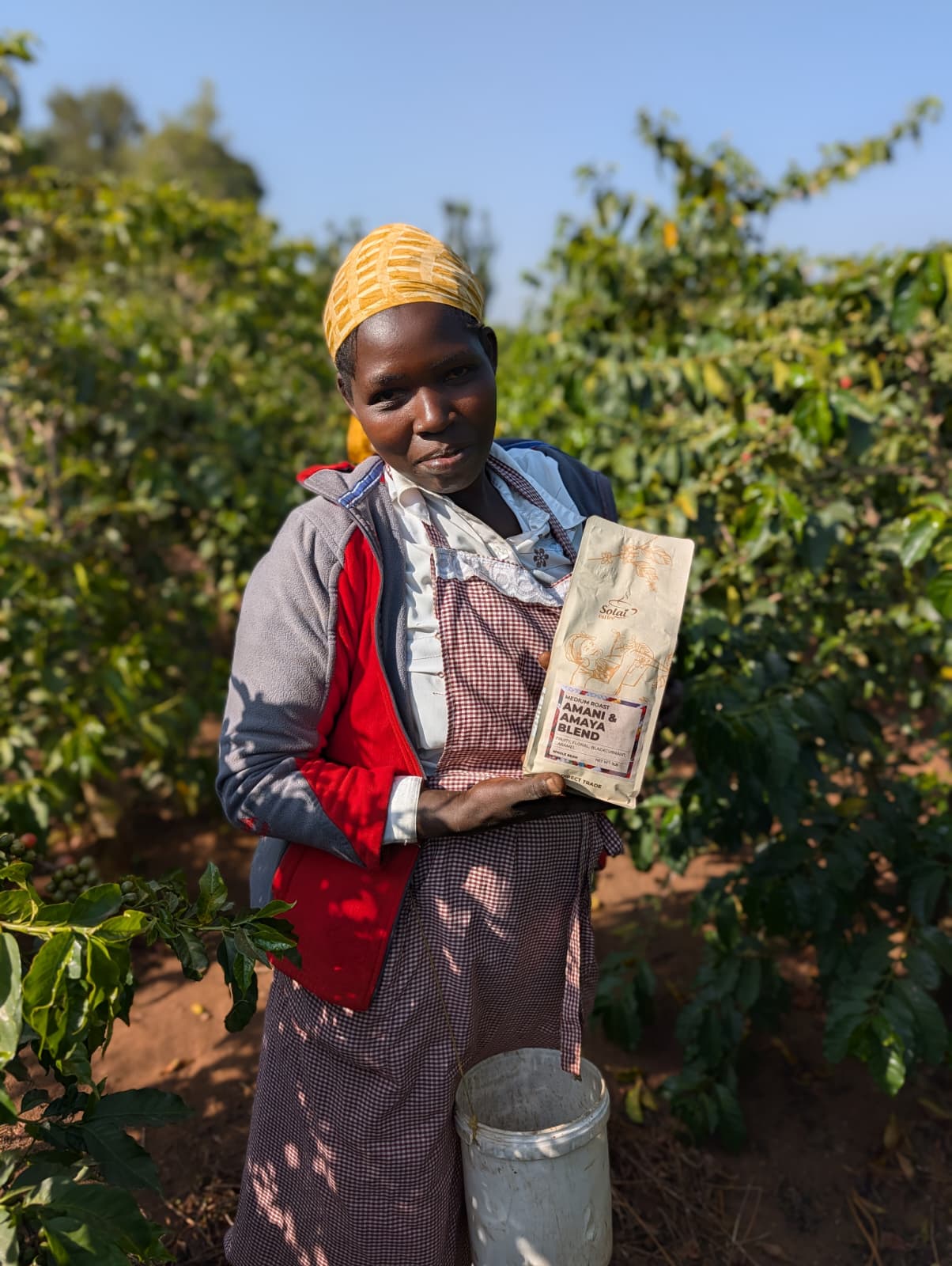 A Kenyan coffee farmer holds the finished Solai Coffee bag
