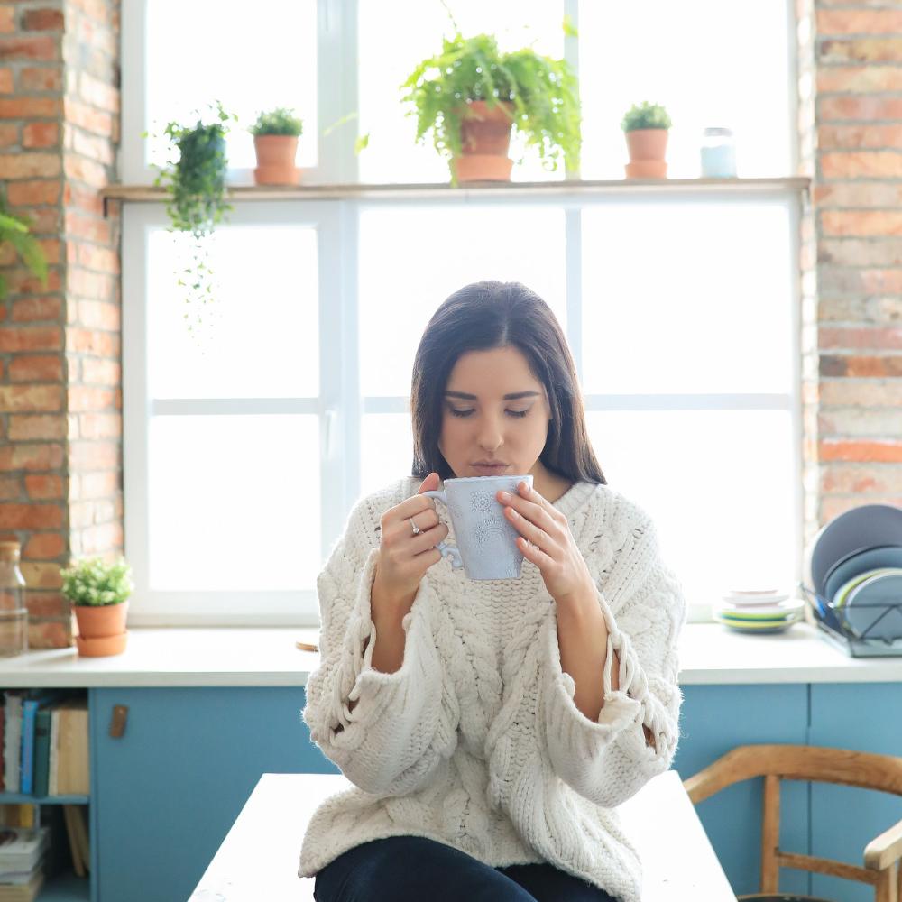 Coffee lover enjoying her daily dose of coffee. It is advisable to drink 4 or 5 cups of coffee a day to avoid addiction.
