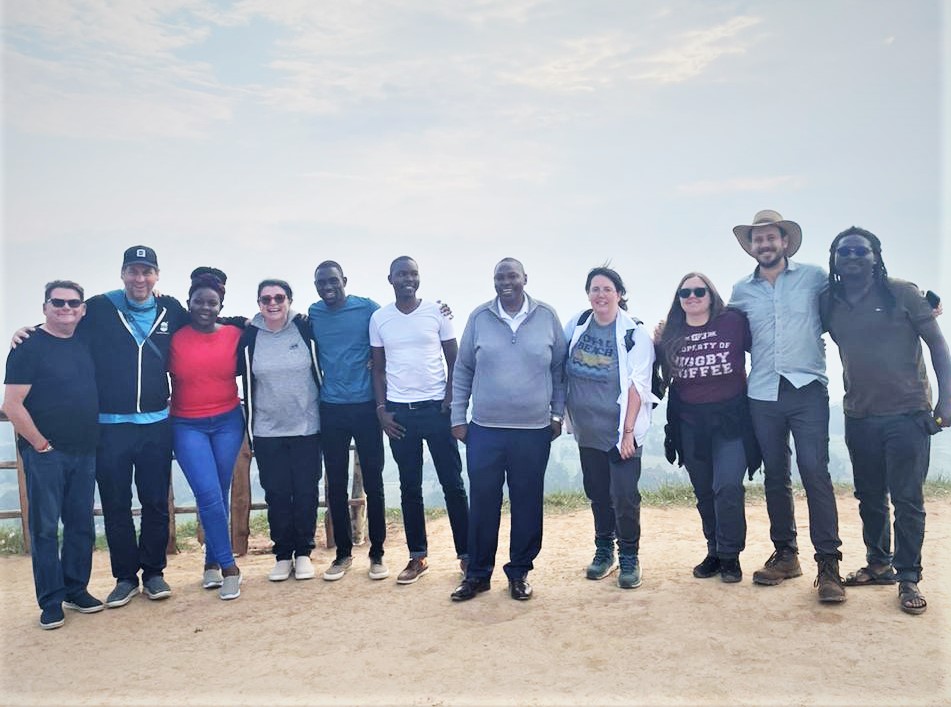 An image showing the Solai coffee team together with One Bigg Island in Space posing for a photo at Kinugi, Rift Valley viewpoint on their way to Nakuru Solai coffee region